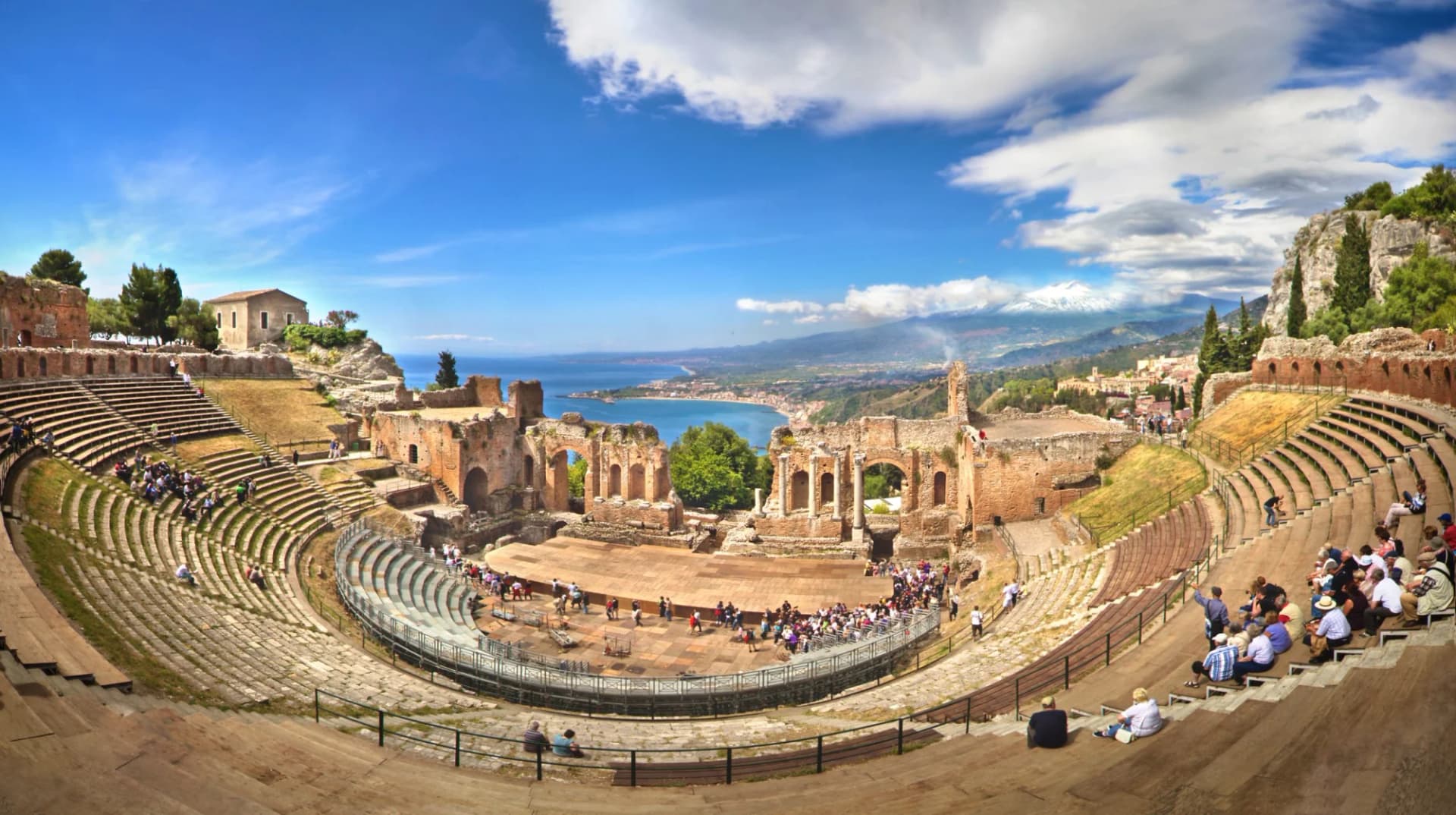 Ancient Greek Theatre in Taormina, Sicily, overlooking the sea and Mount Etna.