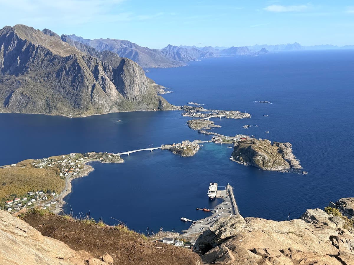 Coastal village connected by bridges with mountain backdrop and blue sea