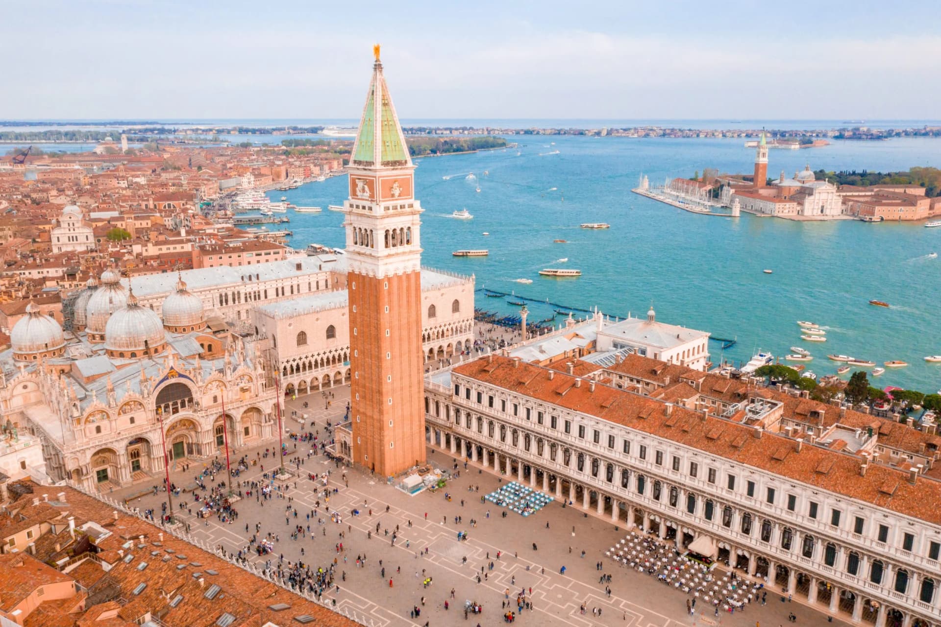 Aerial view of St. Mark's Square, Campanile, and Basilica overlooking the lagoon in Venice.