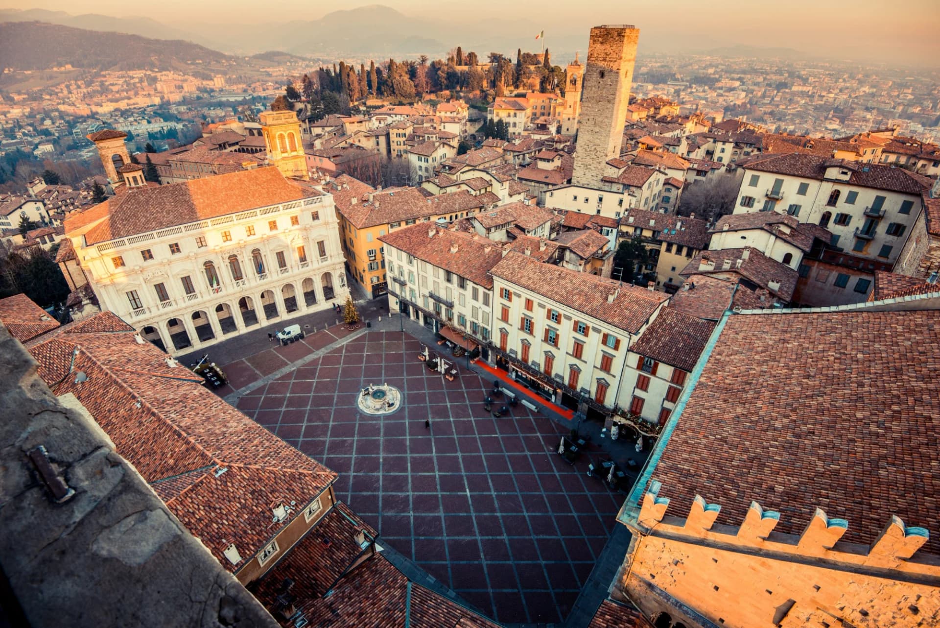 Aerial view of Piazza Vecchia square, historic buildings, and tower in Bergamo, Italy.