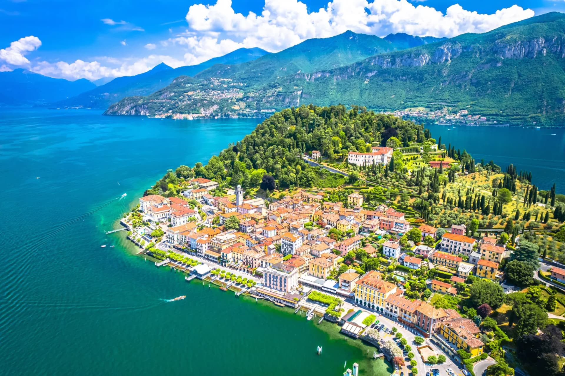 Town of Bellagio on Lake Como with colorful buildings, lush green hills, and blue water.