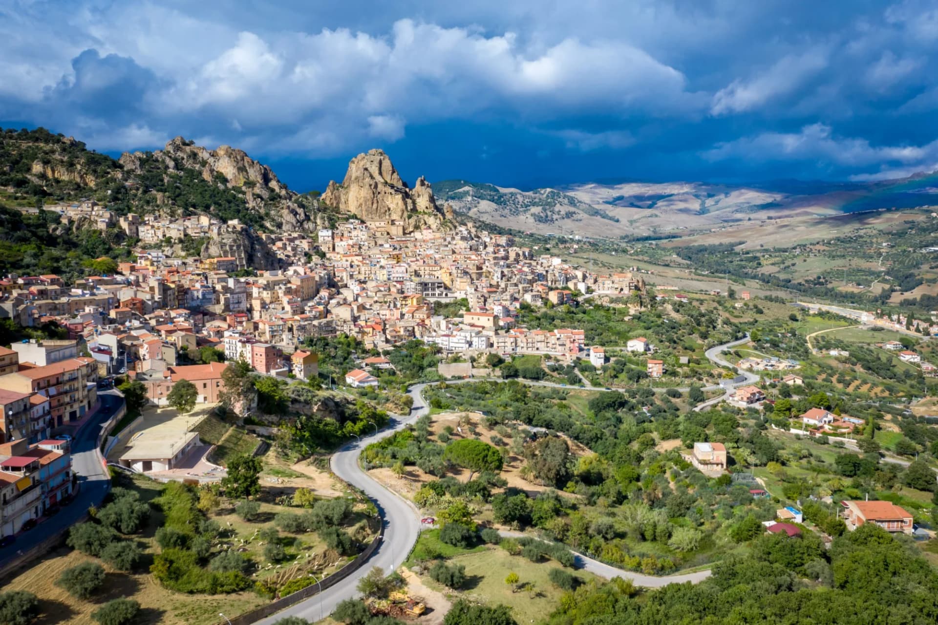 Aerial view of Gagliano Castelferrato, a town built against rocky mountains in Sicily, Italy.