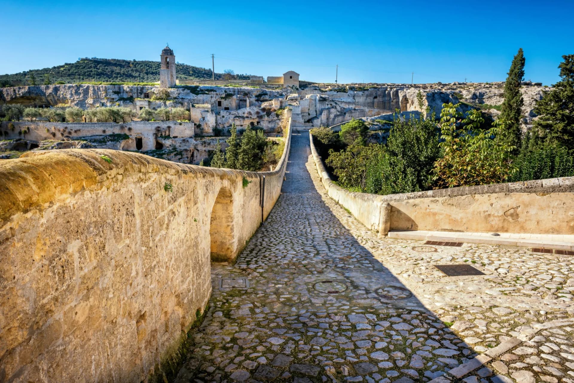 Cobblestone path on Roman two-level bridge above canyon in Gravina in Puglia.