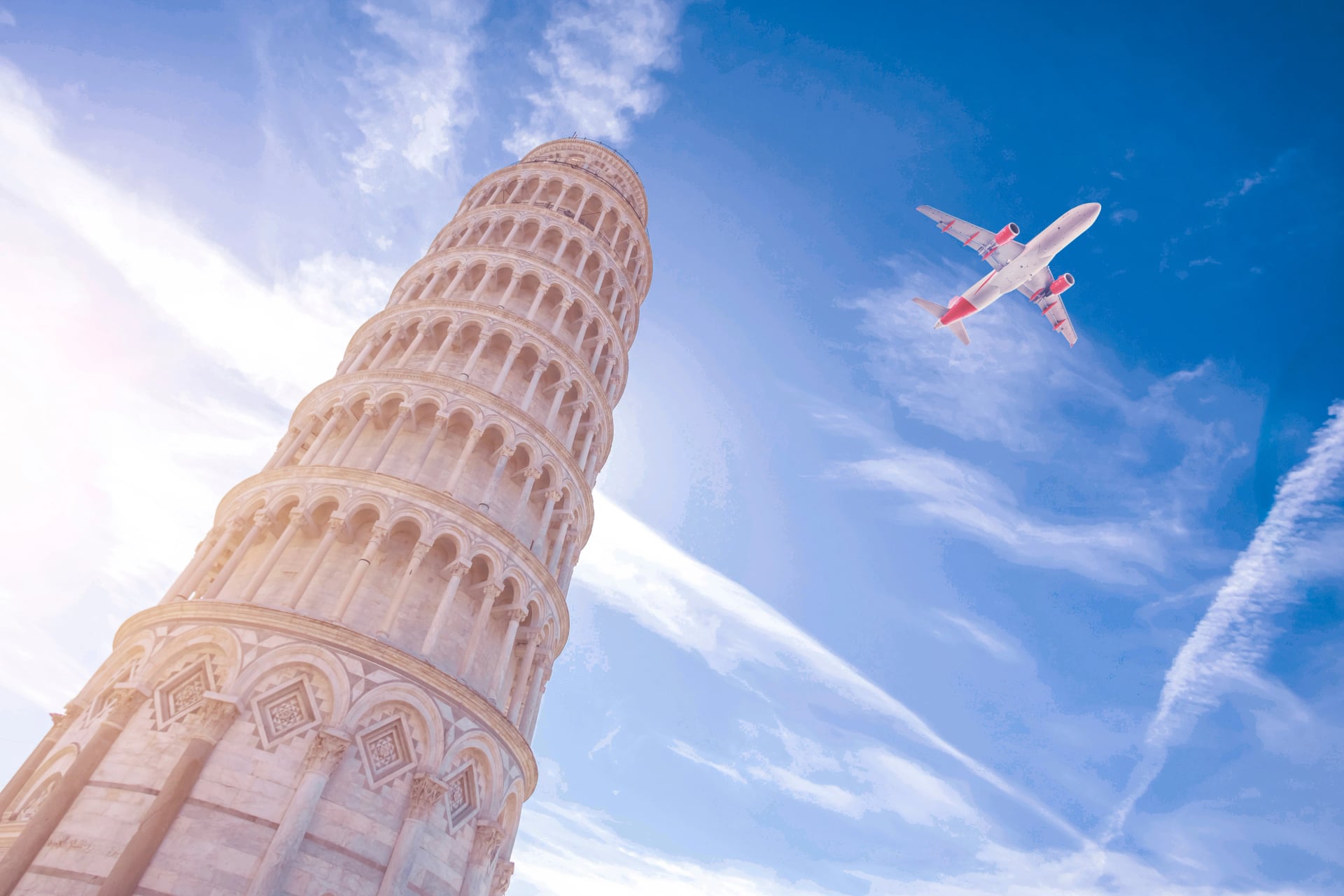 Airplane flying over Leaning Tower of Pisa in Italy