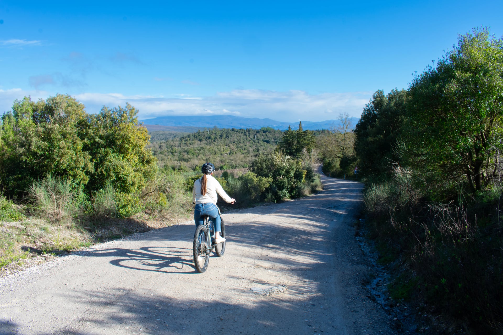 Female on Electric Bike taking a trail ride through Tuscany Italy