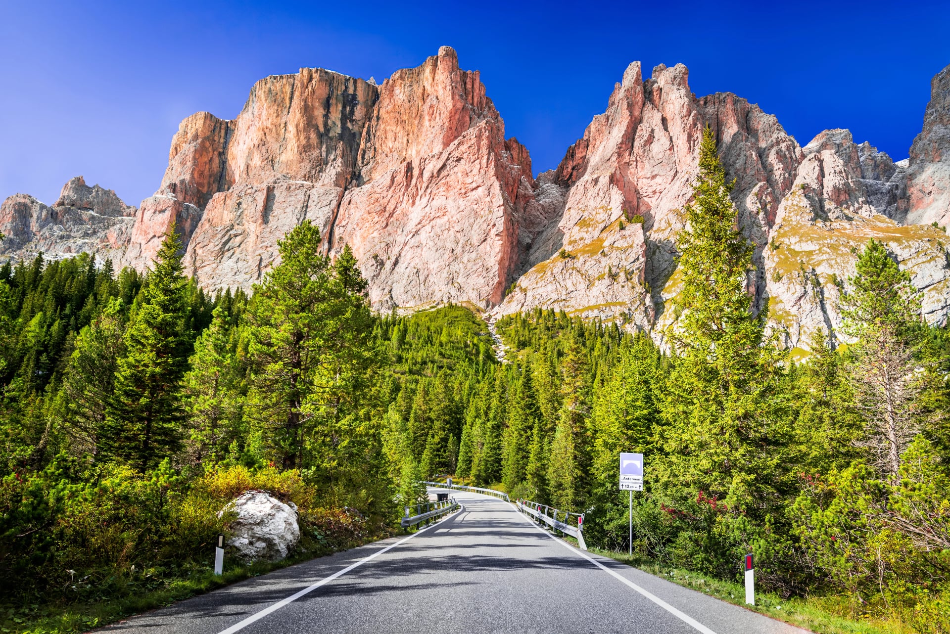 Dolomites, Italy. Sella Ronda mountain ridge and winding road to Sella Pass