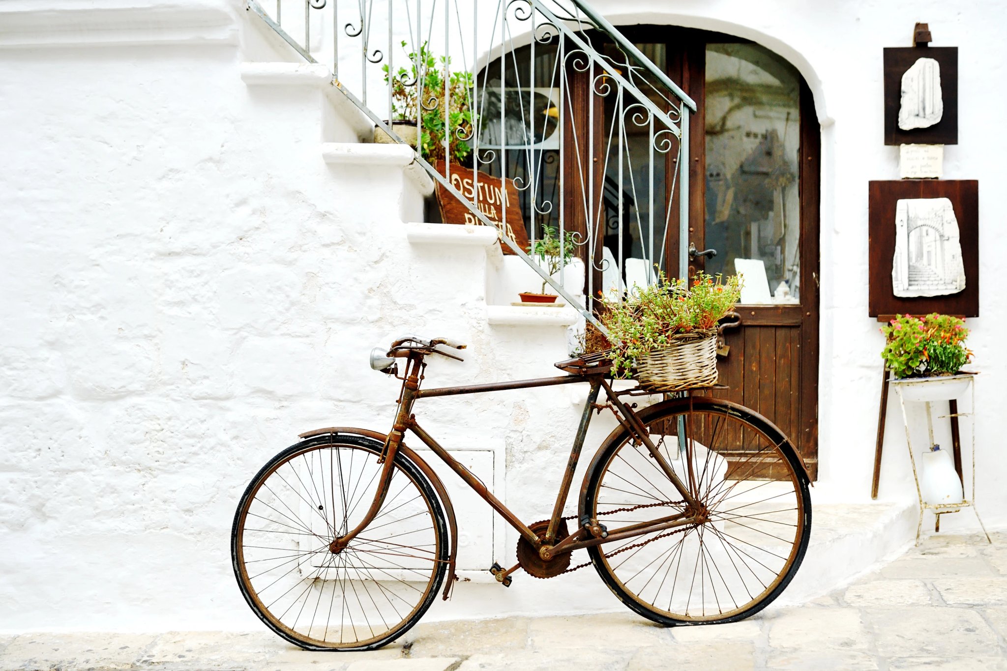 vintage bicycle against a wall in white city Ostuni, Apulia, Italy. - artistic picture italian style concept